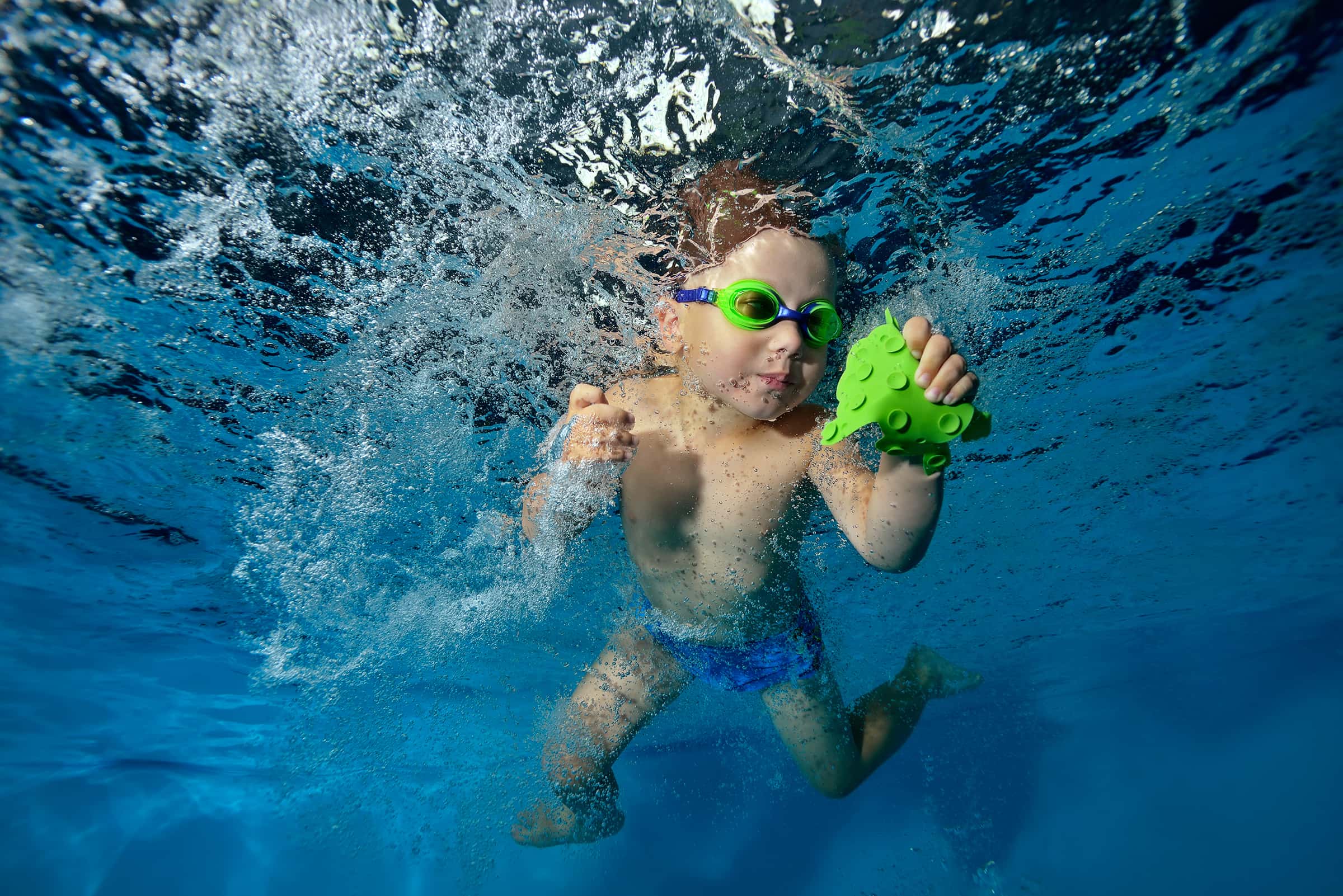 little-boy-playing-underwater-pool-floats-spins-among-air-bubbles